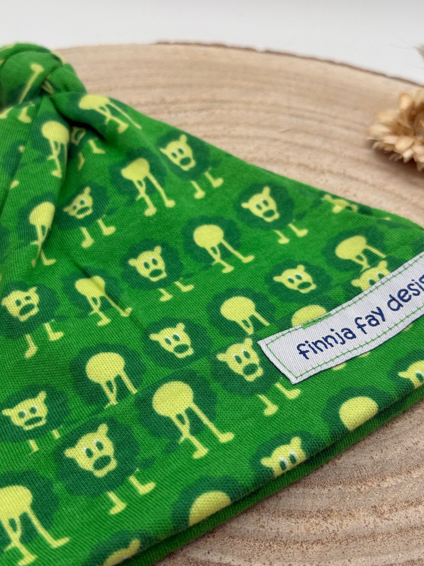 Babymütze mit Knoten – grün mit Löwen Motiv